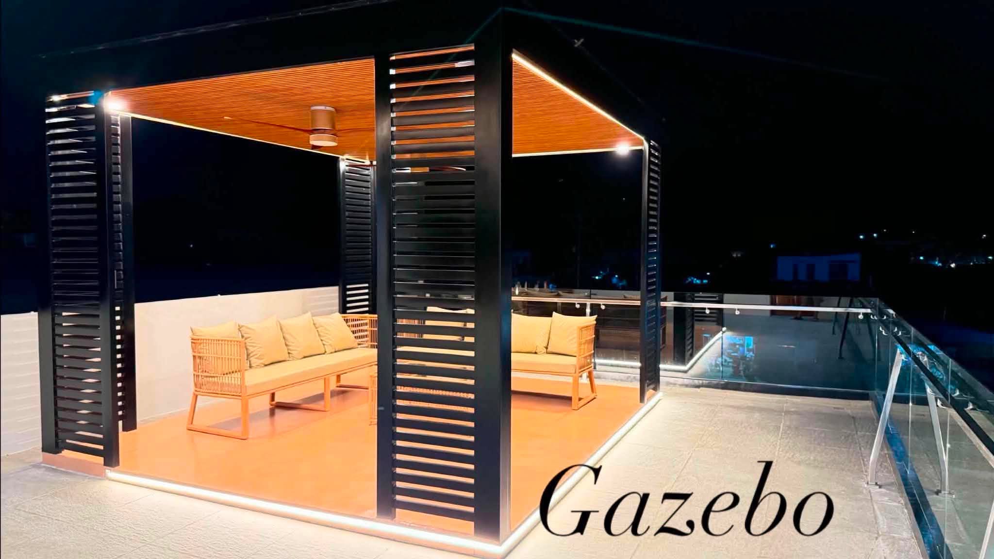 Illuminated poolside gazebo at night